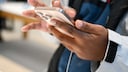 A man holds an iPhone 16 in his hands