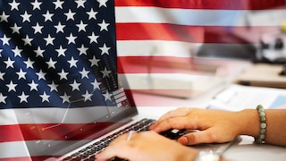 U.S. flag behind laptop