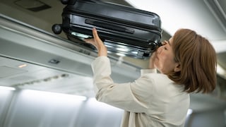 Woman Stows Free Carry-On Luggage