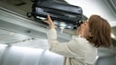Woman Stows Free Carry-On Luggage