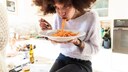 Young Woman Eats Spaghetti as Main Meal