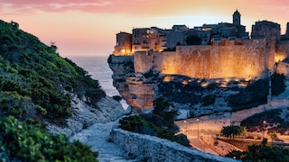 The cliffs of Bonifacio are bathed in the evening light.