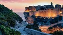 The cliffs of Bonifacio are bathed in the evening light.