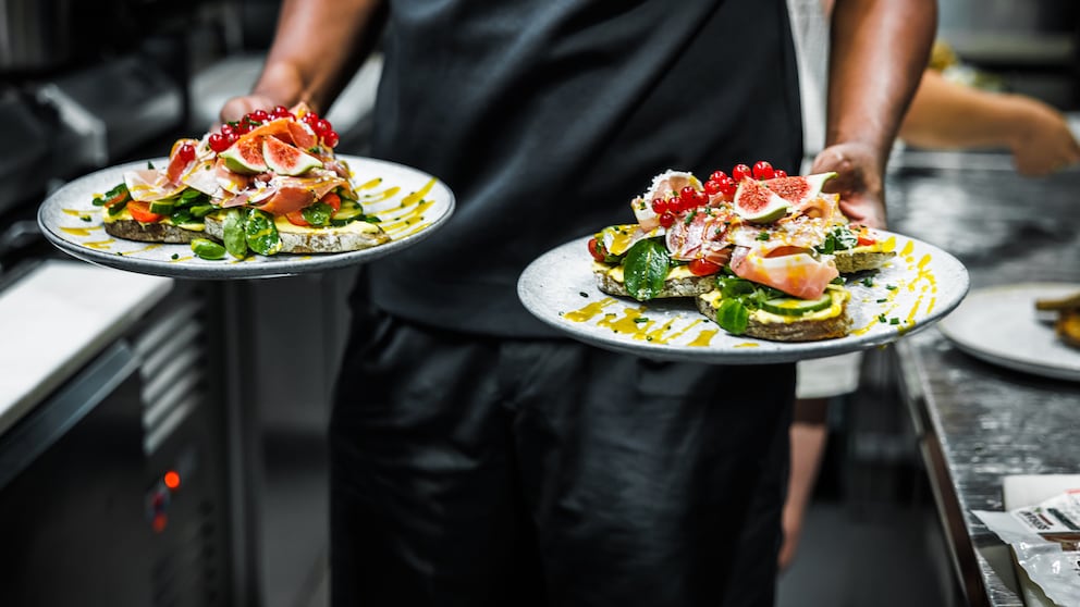 Man with Two Plates in the Restaurant