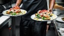 Man with Two Plates in the Restaurant