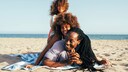 A family is lying on the beach