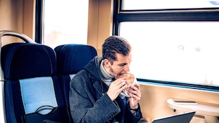 Man Eating on Train