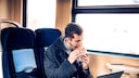 Man Eating on Train