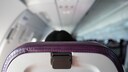 Passenger with Reclined Seatback on Airplane