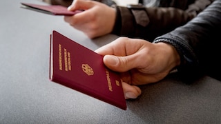 Man holds a passport in his hand