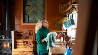 Woman Washing Dishes in Vacation Rental